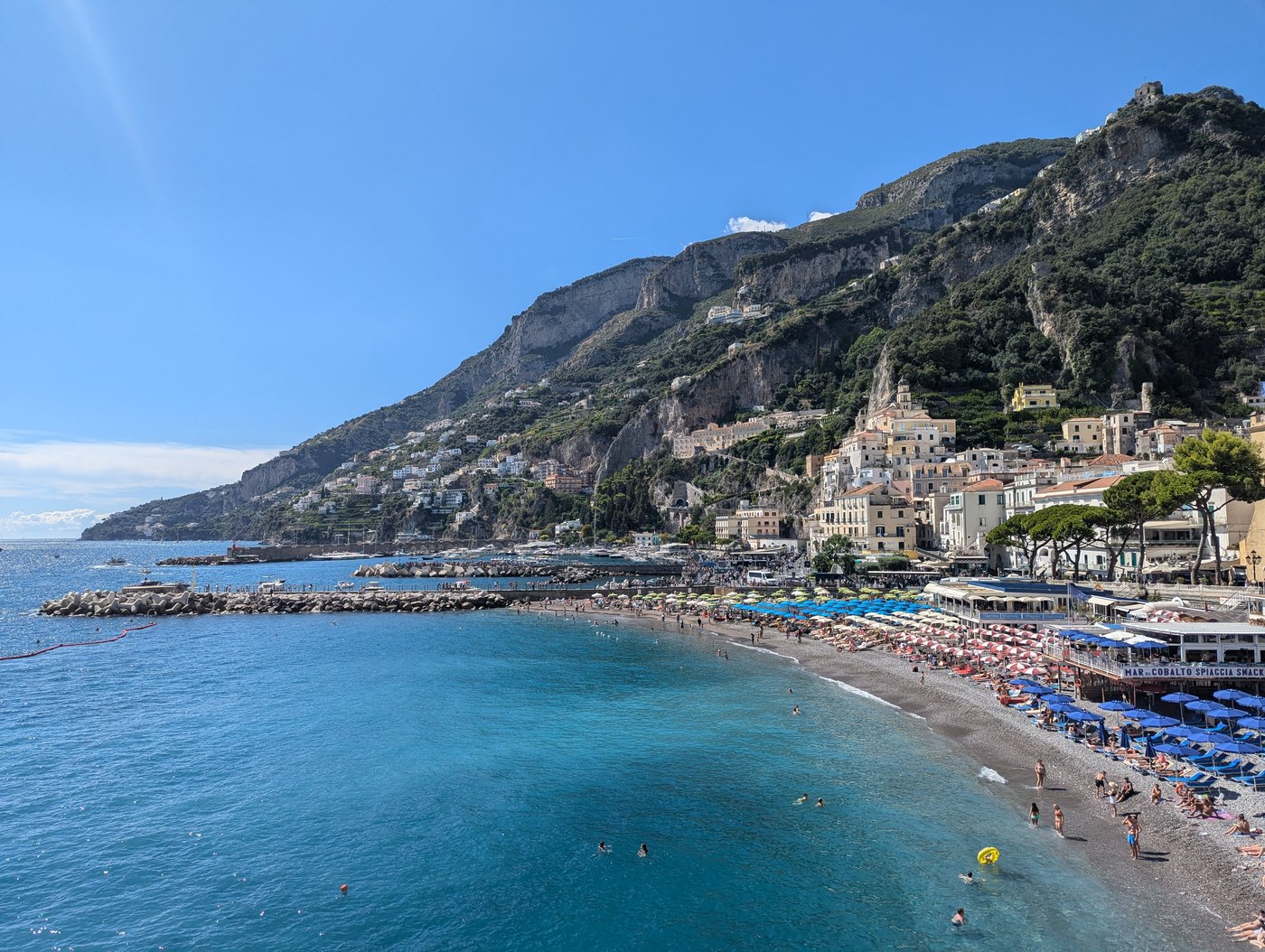 Coastal town on a hillside above a blue bay